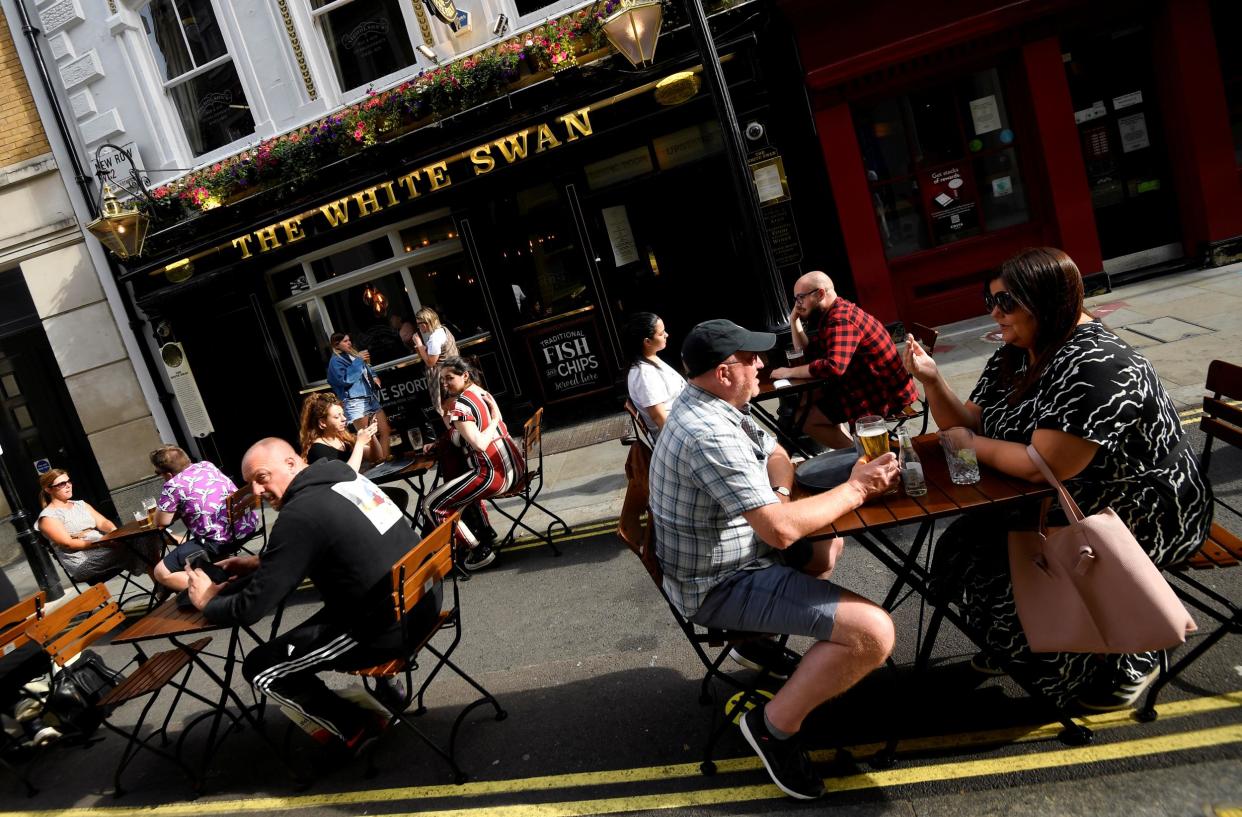 People drink outside a pub at the Covent Garden shopping and dining district, amid the spread of the coronavirus disease: Reuters