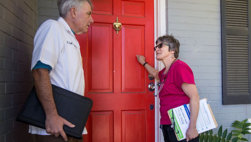 Shirley Belleville and Scott Poppen knock on a door to rally support for a ballot initiative in Salt Lake City on Oct. 13, 2018.