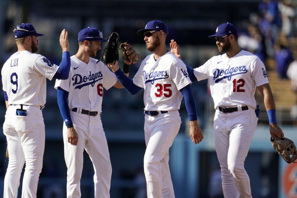 Dodgers' Gavin Lux, Trea Turner, Cody Bellinger and Joey Gallo celebrate the team's 6-1 win over the Colorado Rockies.