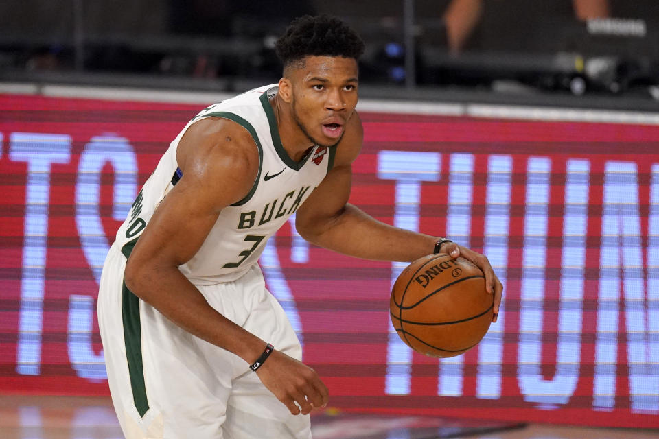 Milwaukee Bucks' Giannis Antetokounmpo (34) advances the ball up court against the Miami Heat during the second half of an NBA basketball conference semifinal playoff game, Monday, Aug. 31, 2020, in Lake Buena Vista, Fla. (AP Photo/Mark J. Terrill)