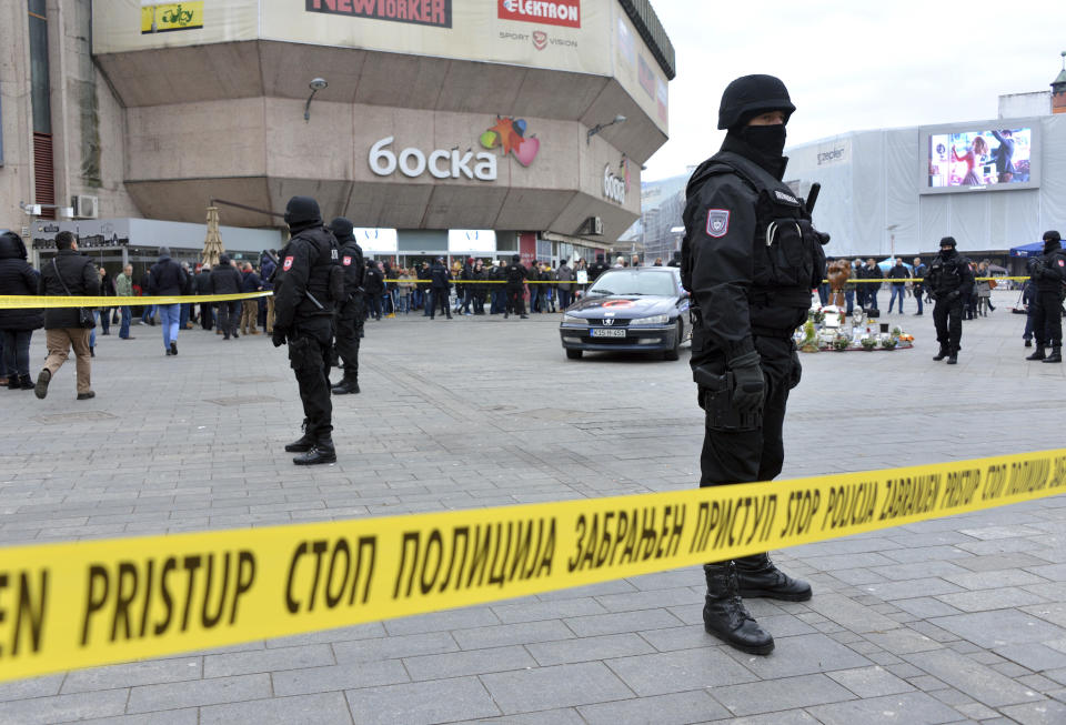 Bosnian Serb police secure an area at the spot where Davor Dragicevic along with members of the "Justice for David" movement protested and demanded the truth behind the death of 21-year-old David Dragicevic in the Bosnian town of Banja Luka, northwest of Sarajevo, Bosnia, Tuesday, Dec. 25, 2018. Bosnian Serb police have detained Davor Dragicevic, the man whose quest for the truth over the death of his son has sparked months of anti-government protests. (AP Photo/Radivoje Pavicic)