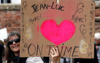 A supporter holds a banners as Jean-Luc Melenchon of the French far left Parti de Gauche and candidate for the 2017 French presidential election holds a political rally in Toulouse, Southwestern France, April 16, 2017. The banners reads "We love you." REUTERS/Regis Duvignau