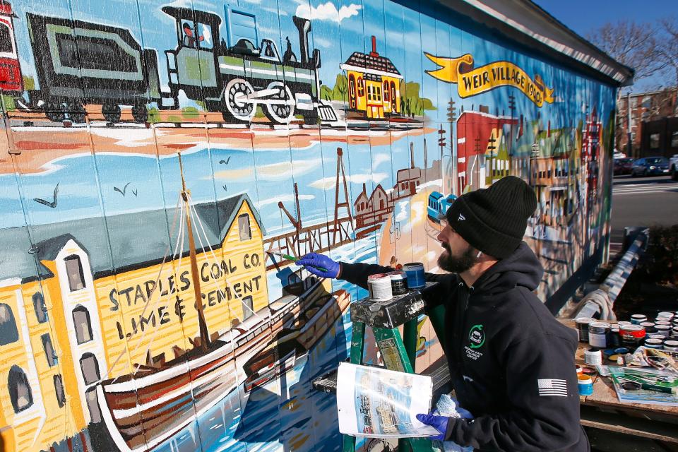 Phill Bourque has returned to Taunton from his home in Hollywood, CA to re-paint a vintage mural on the side of Pistol Pete's Barber Shop at the Weir Village in Taunton.