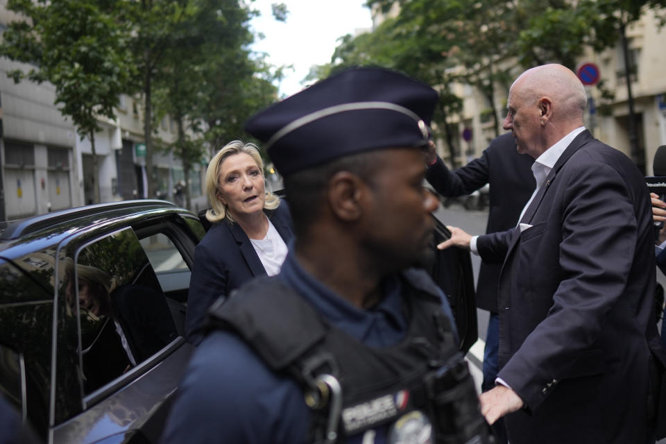 Far-right leader Marine Le Pen, center left, arrives at the National Rally party headquarters, Thursday, July 4, 2024 in Paris. The National Rally secured the most votes in the first round of the early legislative elections on June 30 but not enough to claim an overall victory that would allow the formation of France's first far-right government since World War II. (AP Photo/Thibault Camus)