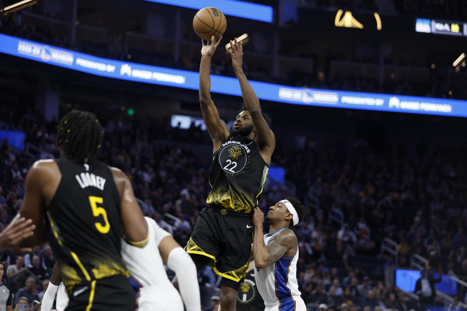 Golden State Warriors forward Andrew Wiggins (22) shoots against Washington Wizards guard Bradley Beal, right, during the first half of an NBA basketball game in San Francisco, Monday, Feb. 13, 2023. (AP Photo/Jed Jacobsohn)