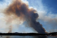 <p>A plume of smoke from burning fires fills the sky in Bormes-les-Mimosas, in the Var department, France, July 26, 2017. (Jean-Paul Pelissier/Reuters) </p>