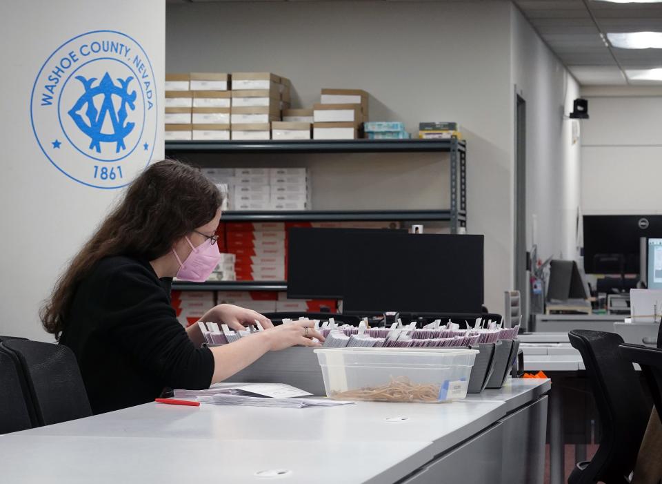 An election worker at the Washoe County Registrar of Voters office sorts through paperwork prior to counting ballots during the Feb. 6, 2024, primary election.