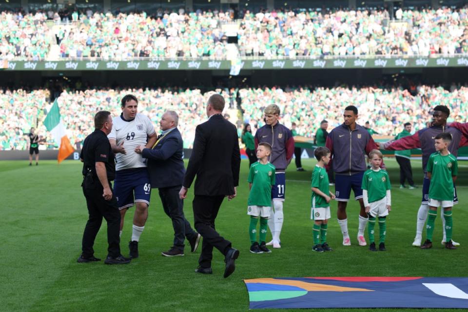 A pitch invader joins the England team line-up  (Getty Images)