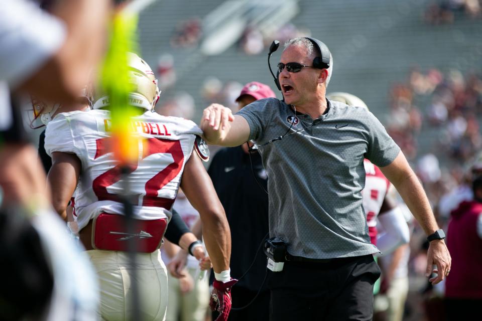 Florida State Seminoles head coach Mike Norvell pats a player on the back after a play. Seminole fans watched as the Florida State football team hosted the FSU Garnet and Gold Spring Showcase on Saturday, April 15, 2023. 