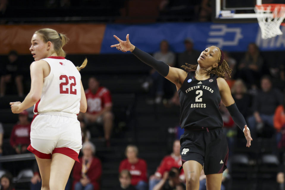 Texas A&M forward Janiah Barker (2) reacts to a Texas A&M basket as she and Nebraska forward Natalie Potts (22) run up the court during the second half of a first-round college basketball game in the women's NCAA Tournament in Corvallis, Ore., Friday, March 22, 2024. (AP Photo/Amanda Loman)