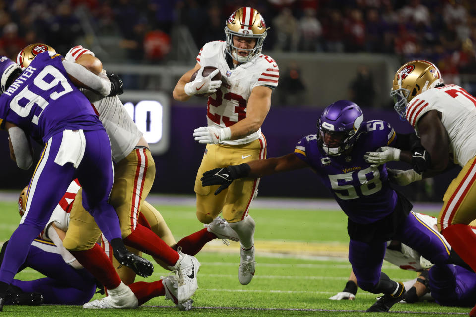 San Francisco 49ers running back Christian McCaffrey (23) runs from Minnesota Vikings linebacker Jordan Hicks (58) during the first half of an NFL football game, Monday, Oct. 23, 2023, in Minneapolis. (AP Photo/Bruce Kluckhohn)