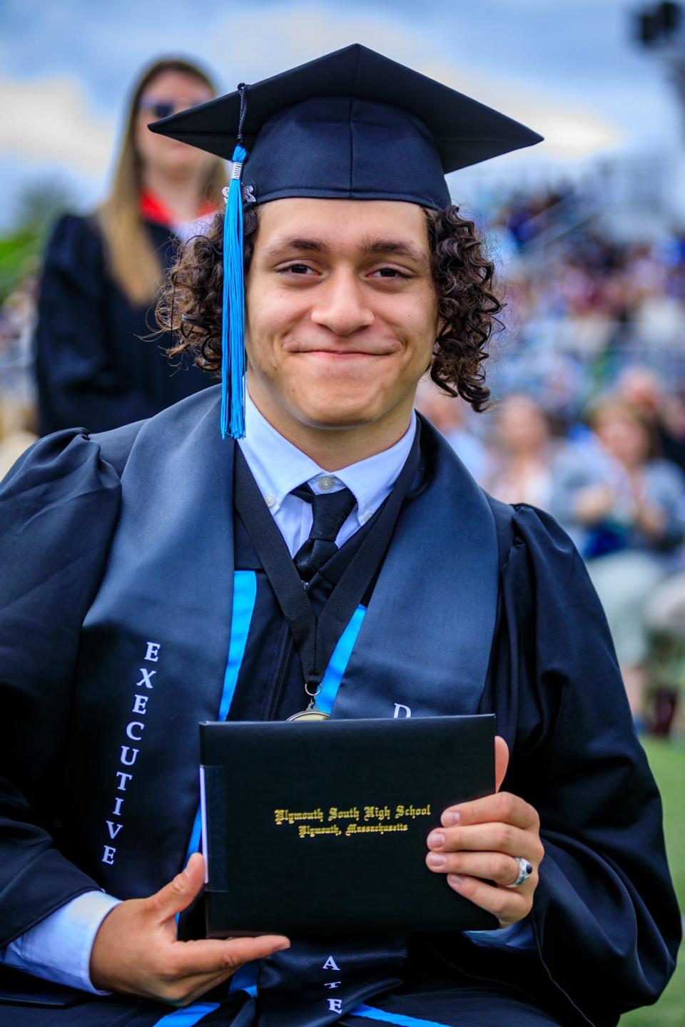 Gabriel D’Agostino shows his diploma during graduation ceremonies at Plymouth South High School on June 4, 2022.