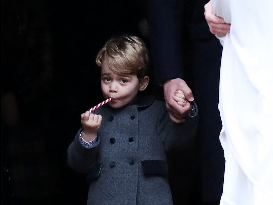 Prince George eats a candy cane.
