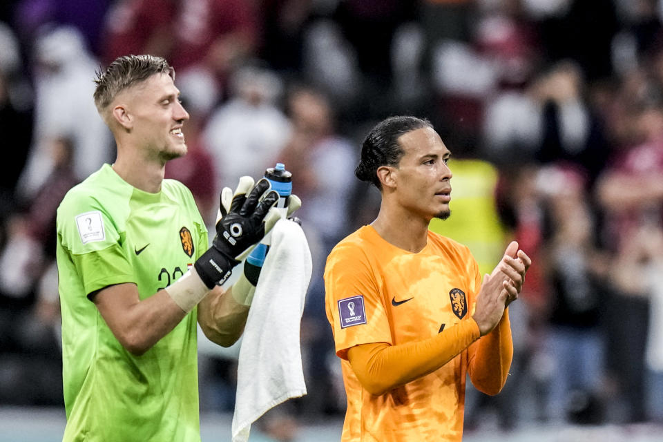Virgil van Dijk of the Netherlands, right, and his teammate goalkeeper Andries Noppert of the Netherlands applaud at the end of the World Cup group A soccer match between the Netherlands and Qatar, at the Al Bayt Stadium in Al Khor , Qatar, Tuesday, Nov. 29, 2022. (AP Photo/Moises Castillo)