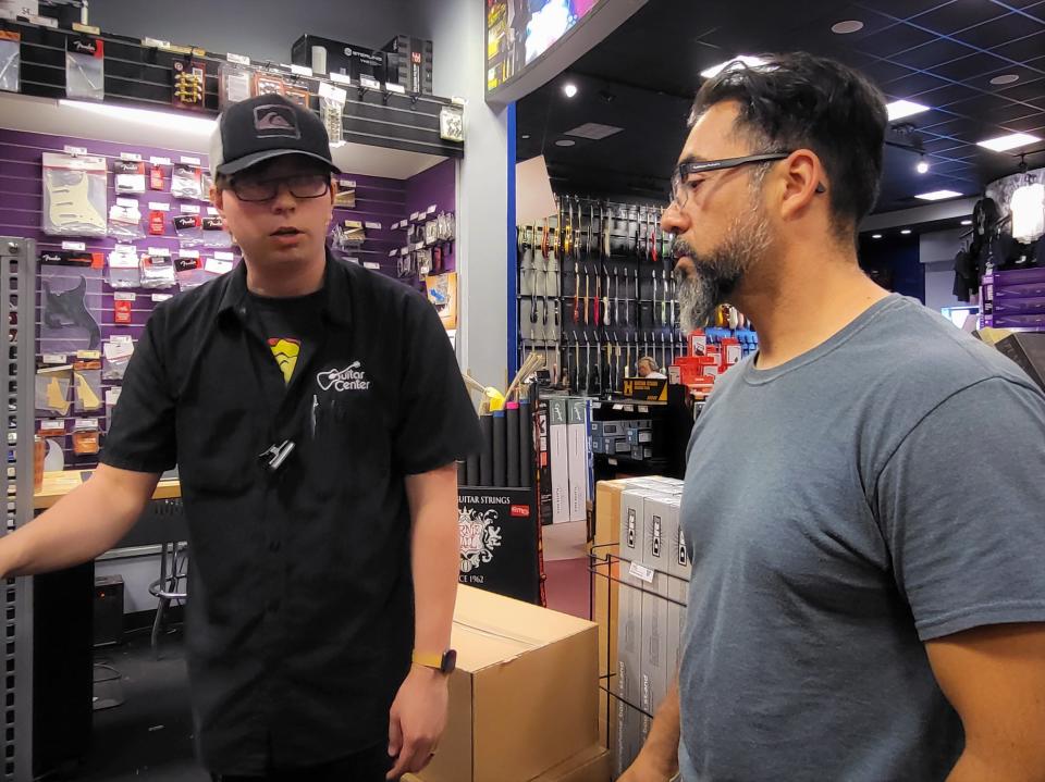 Jesus Rodriguez (right) shops for microphones on Tuesday, September 6, at Guitar Center in Sioux Falls. Rodriquez' sister and daughter are part of the South Dakota Hispanic Chamber of Commerce, which plans to start a Spanish radio station.