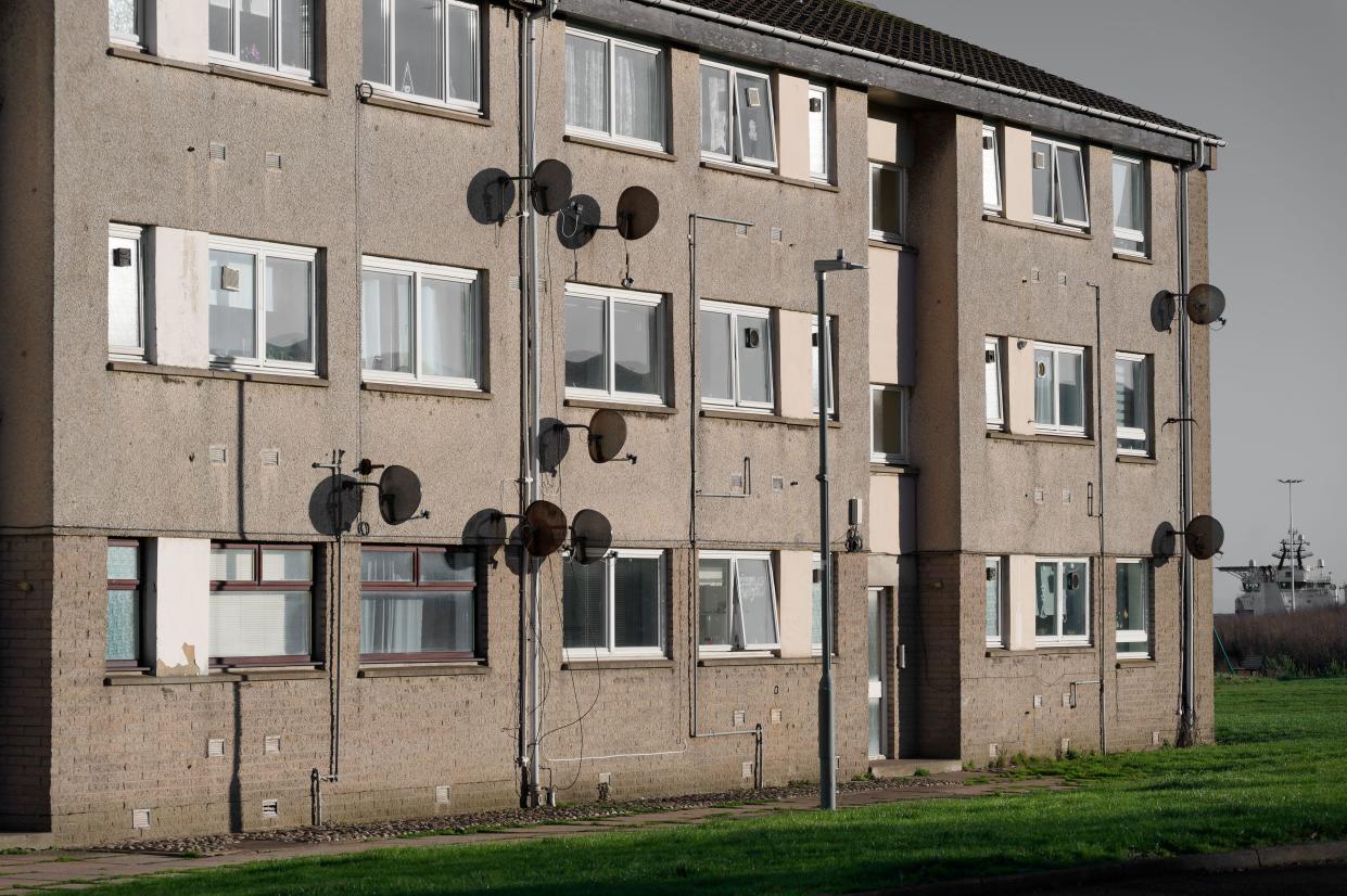 Satellite dish in group on wall of council house