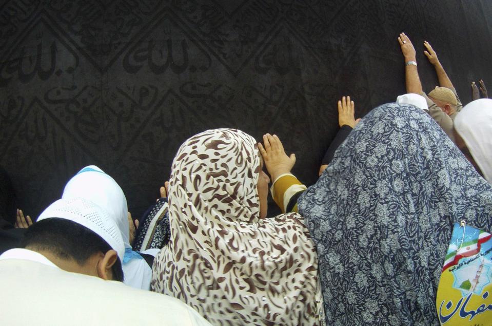 Muslims touch and pray at the Kaaba, during their Umrah Mawlid al-Nabawi pilgrimage, at the Grand Mosque in the holy city of Mecca