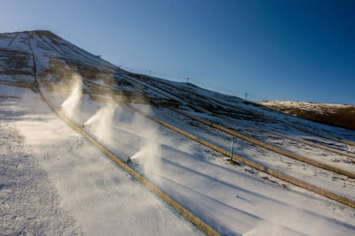 Aerial view of snow cannons spraying artifical snow on a ski slope at El Colorado skiing center in Chile, where climate change and pollution have resulted in diminishing snowfall