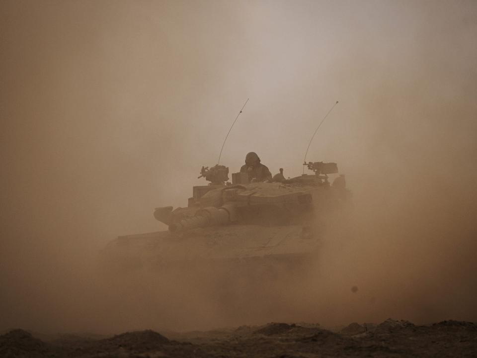 Israeli Merkava battle tank units regroup near the border of Gaza, in the southern part of Israel, Saturday, Oct. 14, 2023.