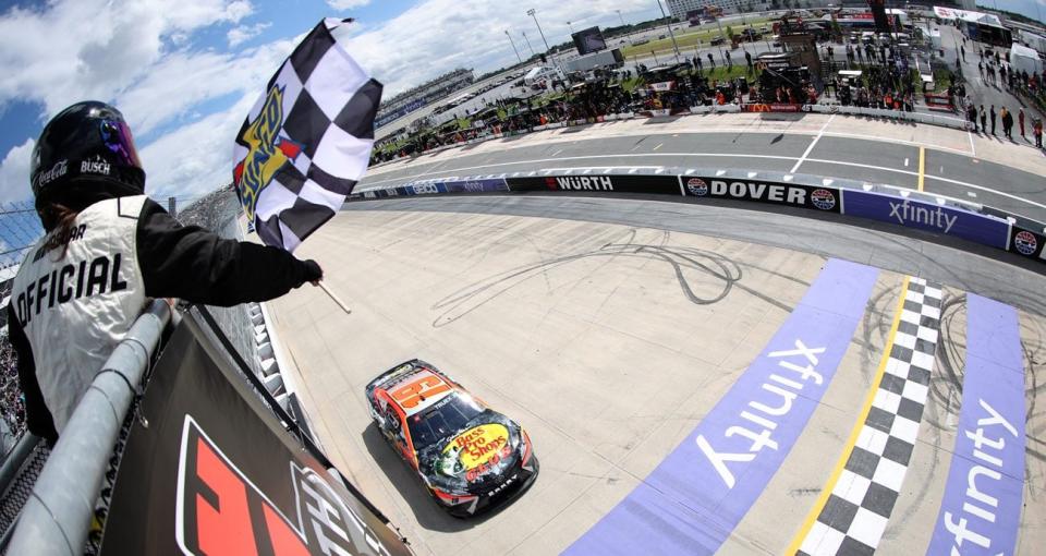 Martin Truex Jr. takes the checkered flag to win at Dover.