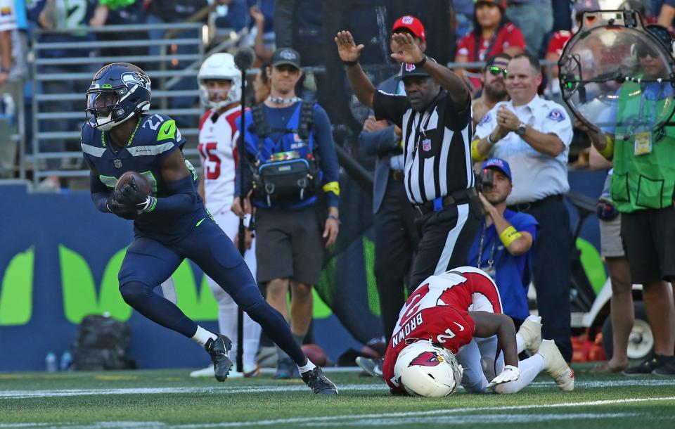 Tariq Woolen #27 of the Seattle Seahawks intercepts a pass intended for Marquise Brown #2 of the Arizona Cardinals during the fourth quarter at Lumen Field on October 16, 2022, in Seattle, Washington.