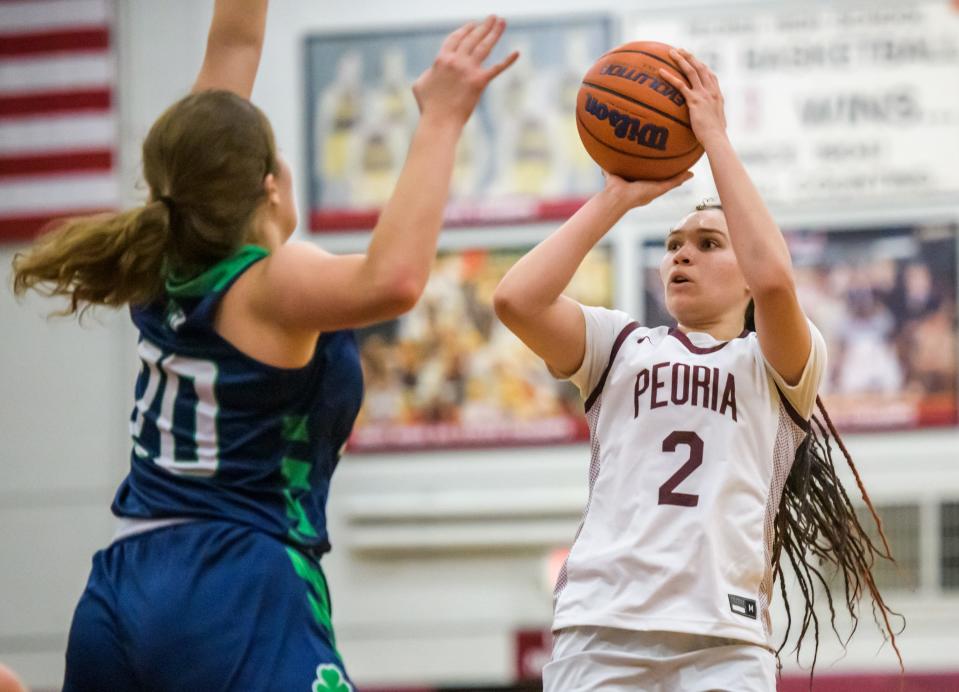 Peoria High's Denali Craig Edwards (2) shoots over Peoria Notre Dame's Biz Daly in the second half Thursday, Dec. 1, 2022 at Peoria High School. The Irish defeated the Lions 60-47.