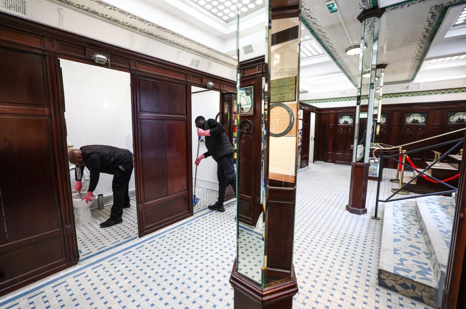 Employees clean the public toilets of the Lavatory de La Madeleine