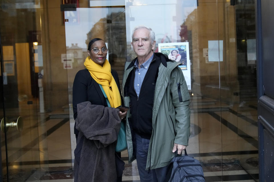 President of the Collective of Civil Parties for Rwanda Alain Gauthier and his wife Dafroza wait at Paris court house, Thursday, Nov. 23, 2023 as Sosthene Munyemana, a Rwandan doctor arrives on trial over his alleged role in the 1994 genocide in his home country. Munyemana who has been living in France for decades faces charges of genocide, crimes against humanity and complicity in such crimes. (AP Photo/Christophe Ena)