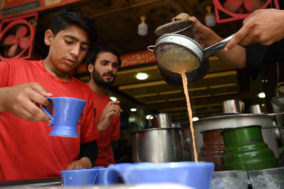 Waiters prepare to serve tea to customers at a restaurant in Islamabad, Pakistan, June 15, 2022. / Credit: AAMIR QURESHI/AFP/Getty
