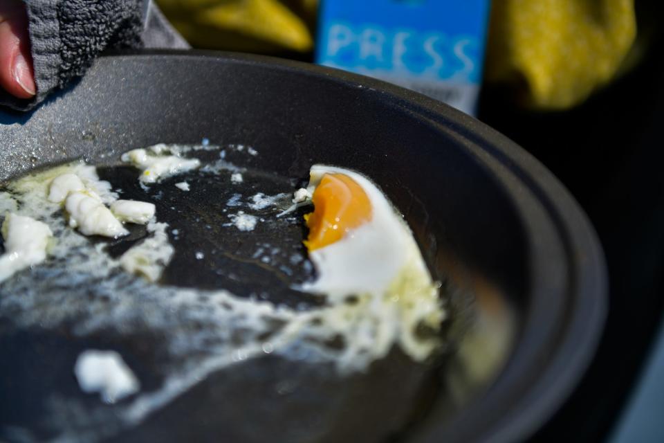 The Tennessean employees cook and eat an egg outside as temperatures reached triple digits in Nashville