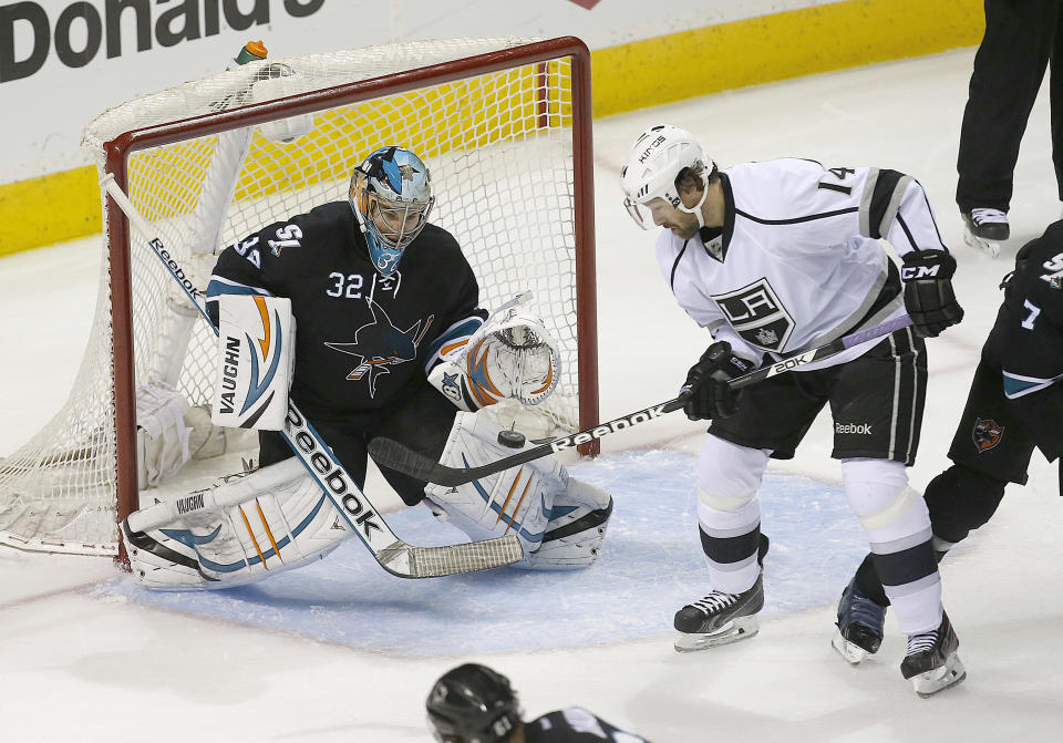 San Jose Sharks goalie Alex Stalock (32) blocks a goal attempt by Los Angeles Kings right wing Justin Williams (14) during the third period of Game 4 of an NHL hockey first-round playoff series in San Jose, Calif., Saturday, April 26, 2014. Los Angeles won 3-0. (AP Photo/Tony Avelar)