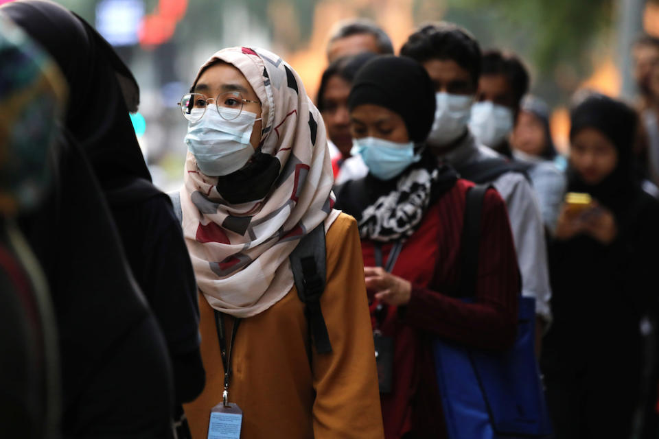 Passengers wear masks at a bus station in Kuala Lumpur January 31, 2020. — Reuters pic