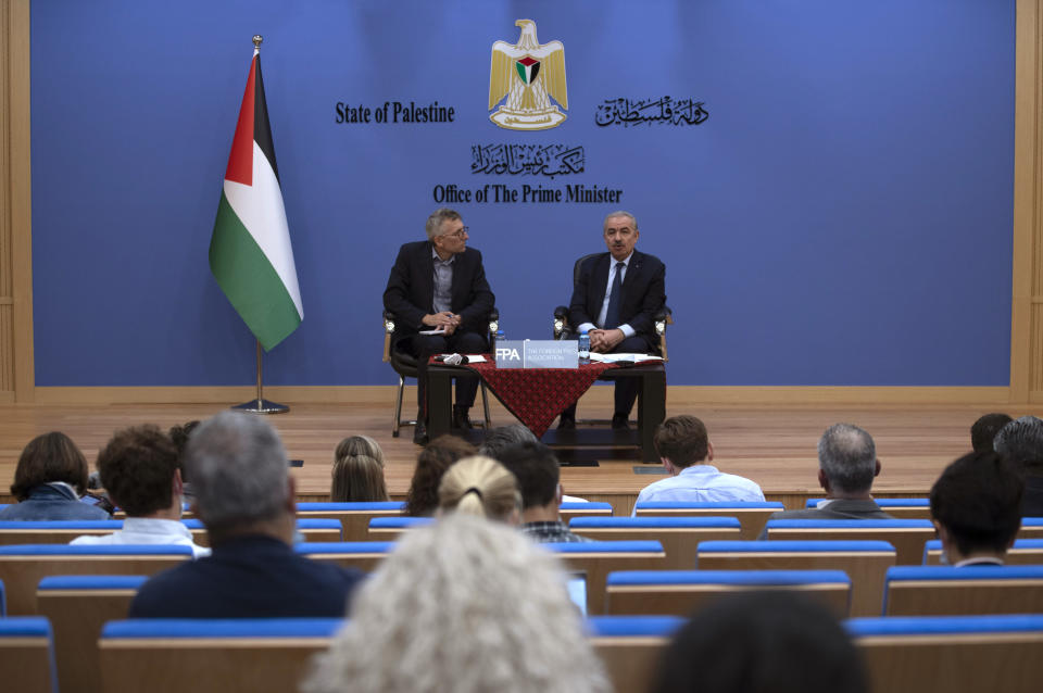 Palestinian Prime Minister Mohammad Shtayyeh, right, holds a briefing with foreign press alongside Andrew Carey, chairman of the Foreign Press Association (FPA), in the West Bank city of Ramallah, Wednesday, Nov. 10, 2021. (AP Photo/Majdi Mohammed)