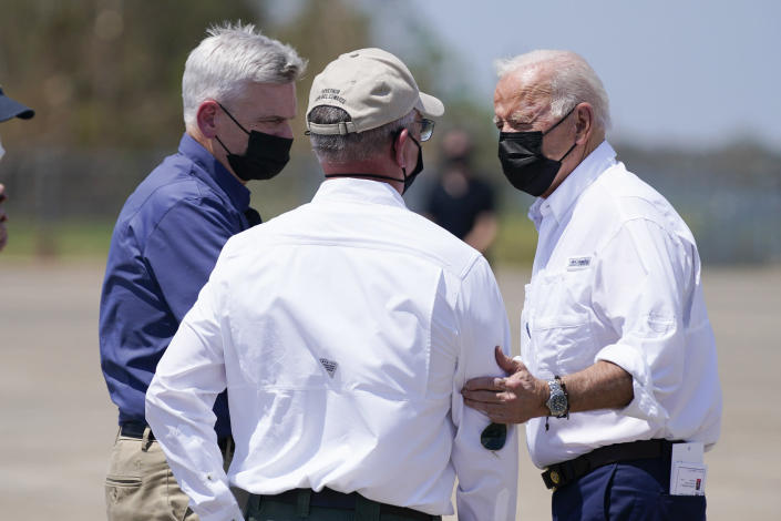 President Joe Biden talks with Louisiana Gov. John Bel Edwards and Sen. Bill Cassidy, R-La., left, as he arrives at Louis Armstrong New Orleans International Airport in Kenner, La., Friday, Sept. 3, 2021, to tour damage caused by Hurricane Ida. (AP Photo/Evan Vucci)