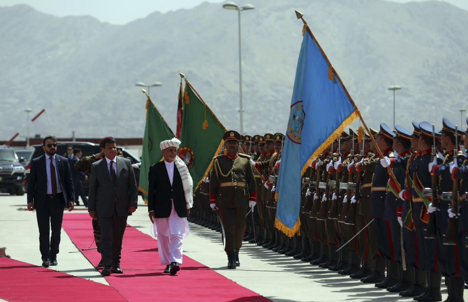President Ashraf Ghani, center, inspects the honor guard during the extraordinary meeting of the Parliament in Kabul, Afghanistan, Monday, Aug. 2, 2021. (AP Photo/Rahmat Gul)