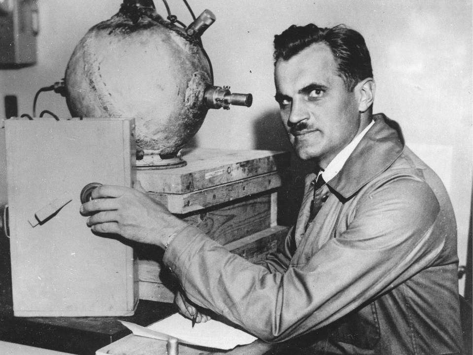 Nobel Prize winner Arthur Compton sits near a piece of laboratory equipment cirica 1932.