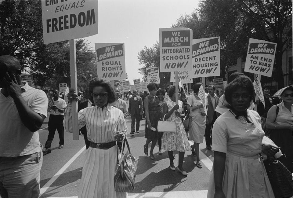 A procession of protesters carrying signs for equal rights, integrated schools, decent housing, and an end to bias in Washington, D.C., on Aug. 28, 1963. (Warren K. Leffler / Library of Congress)