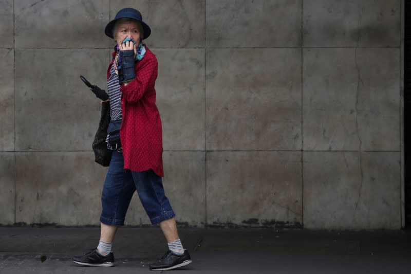 A woman protects her face with a scarf amid the coronavirus disease (COVID-19) outbreak in Sao Paulo