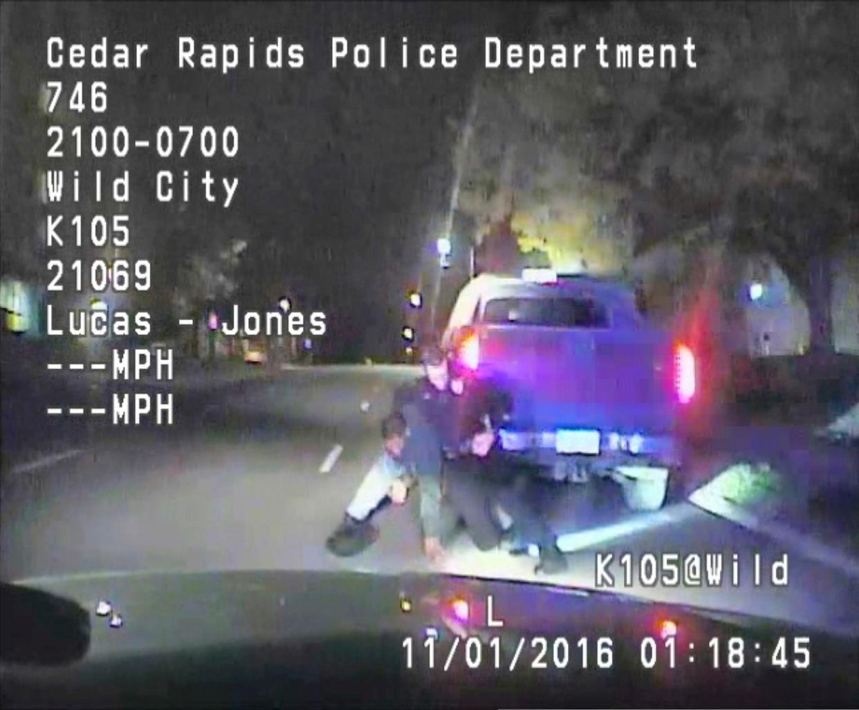 FILE--In this file image made from a Nov. 1, 2016 dashcam video released by Cedar Rapids Police Department, unarmed black motorist Jerime Mitchell struggles with officer Lucas Jones before the driver is shot and paralyzed. 
