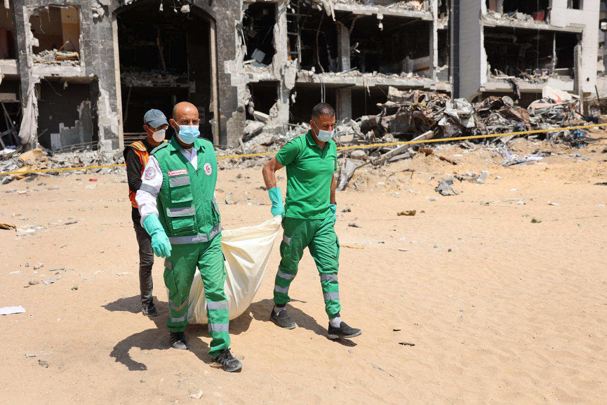 Palestinian forensic and civil defence recover human remains at Al-Shifa hospital in Gaza (AFP- Getty Images)