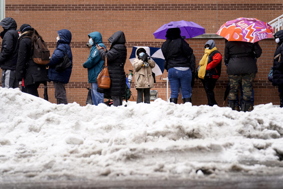 People wait in line at a 24-hour, walk-up COVID-19 vaccination clinic hosted by the Black Doctors COVID-19 Consortium at Temple University's Liacouras Center in Philadelphia, Friday, Feb. 19, 2021. (AP Photo/Matt Rourke)