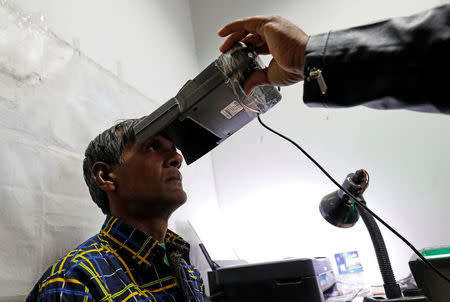 A man goes through the process of eye scanning for the Unique Identification (UID) database system, also known as Aadhaar, at a registration centre in New Delhi, India, January 17, 2018. . REUTERS/Saumya Khandelwal