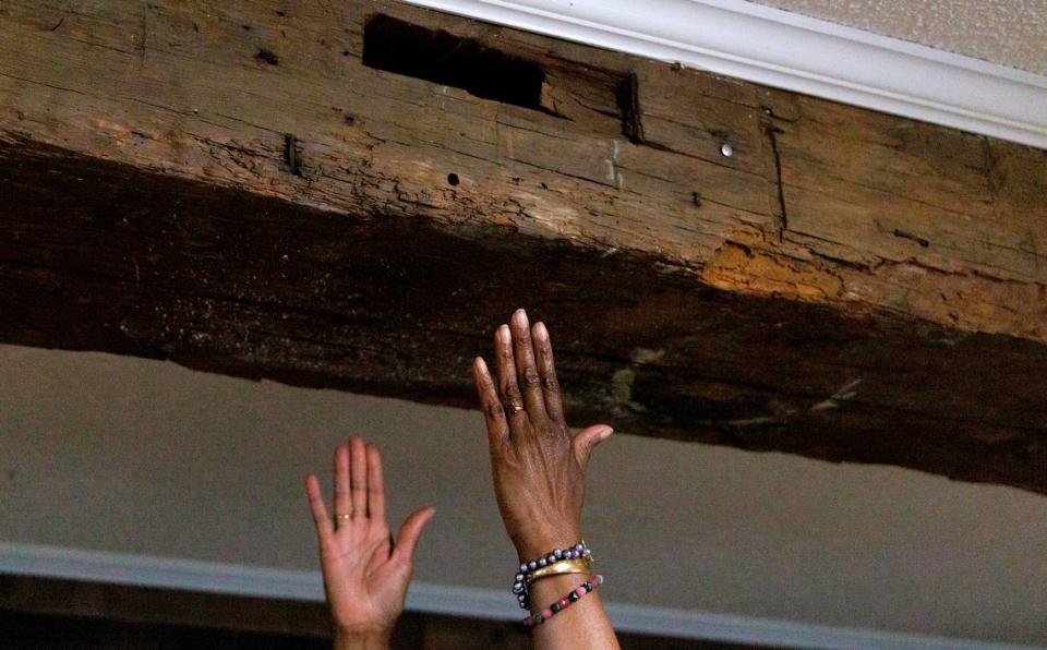 Retired Judge Beverly Scarlett points out a portion of the original timber frame of Dickerson Chapel AME Church on Thursday, April 18, 2024, in Hillsborough, N.C. Built in 1790, the building originally housed Orange County’s courts, where Black people were sold into slavery, punished for crimes they often didn’t commit, and Black and Indigenous children born free were taken away to be involuntary “apprentices.”