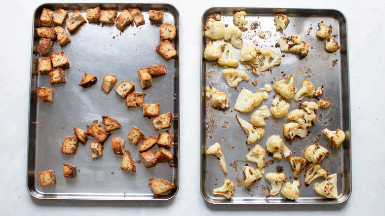 roasted cauliflower and croutons on baking sheets