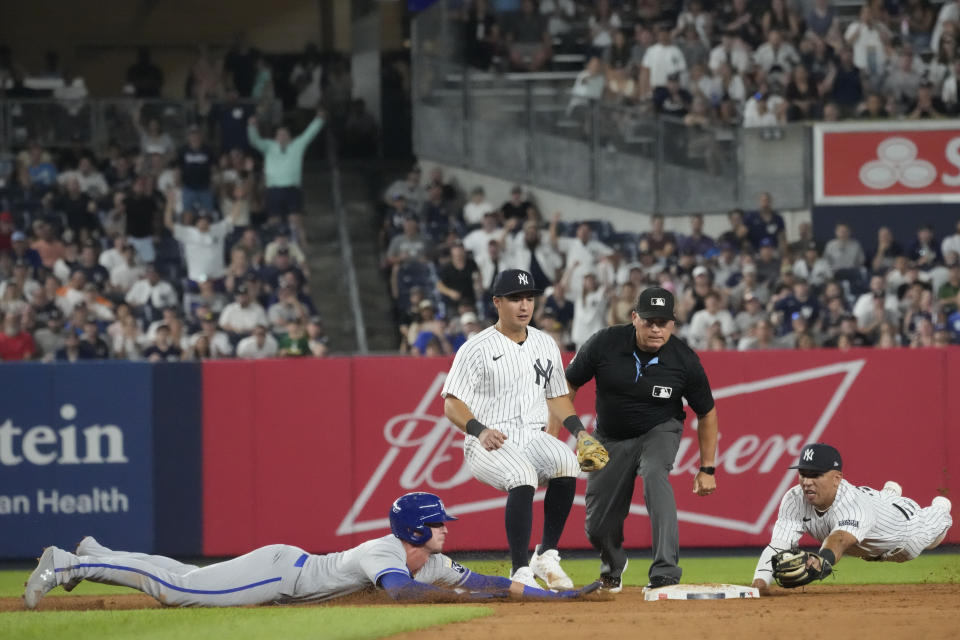 Kansas City Royals' Drew Waters, left, slides safely into second past New York Yankees second baseman Oswald Peraza, right, in the ninth inning of a baseball game, Friday, July 21, 2023, in New York. (AP Photo/Mary Altaffer)