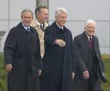 <p>Bill Clinton waves from the stage accompanied by George W. Bush, Jimmy Carter and George H.W. Bush during the official opening ceremony of the Clinton Presidential Library on Nov. 18, 2004, in Little Rock, Arkansas. </p>