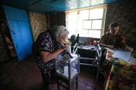 A local resident casts her vote into a mobile ballot box during Ukraine's parliamentary election in Kiev Region