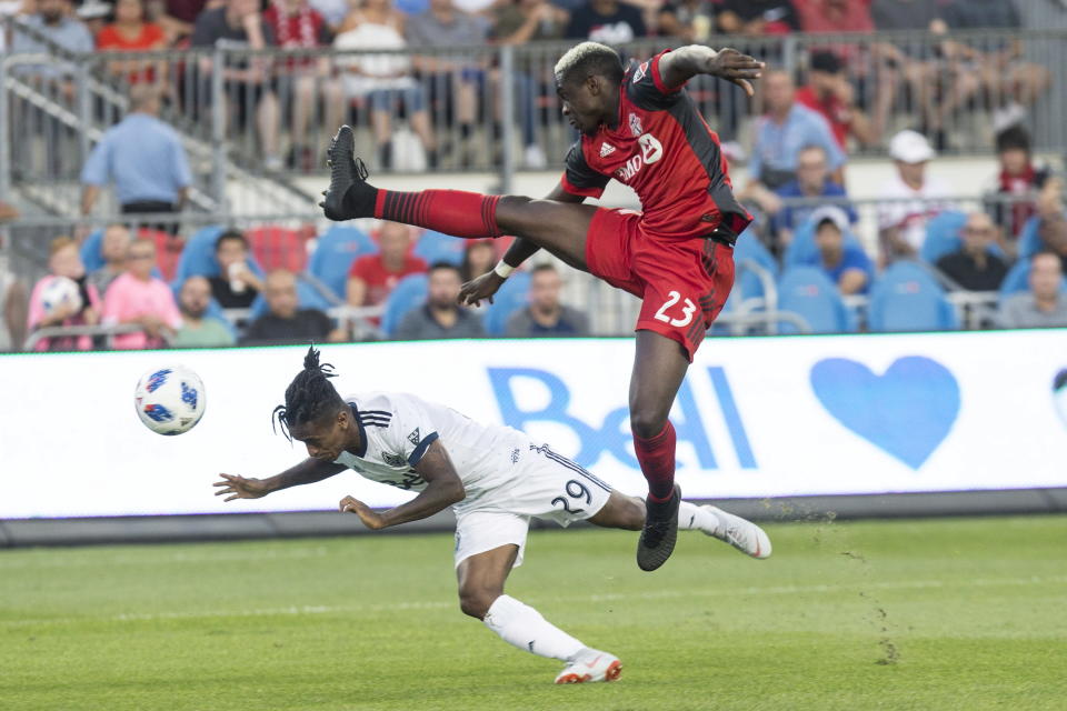 Vancouver Whitecaps forward Yordi Reyna, left, dives to get a header in front of Toronto FC defender Chris Mavinga during the first half in the second leg of the Canadian soccer championship final, Wednesday, Aug. 15, 2018, in Toronto. (Chris Young/The Canadian Press via AP)