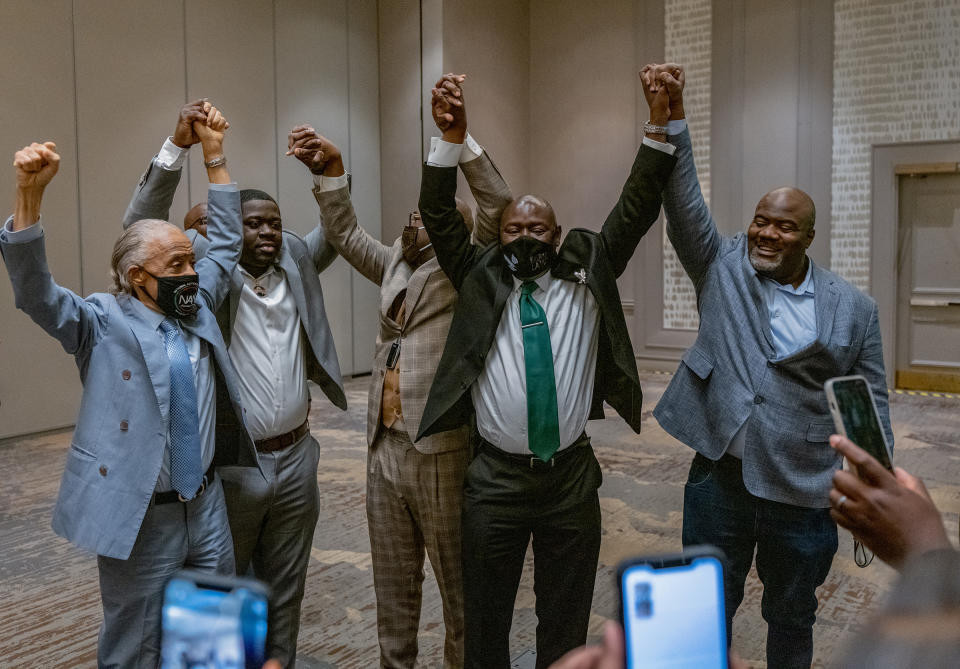 Attorney Ben Crump (C), with Reverend Al Sharpton (L) and members of George Floyd's family, reacts following the guilty verdict in the trial of former police officer Derek Chauvin in Minneapolis on April 20.<span class="copyright">Ruddy Roye for TIME</span>