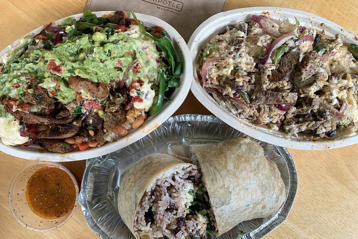 HYATTSVILLE, MD - SEPTEMBER 12: New in September 2022, Chipotle's garlic guajillo steak is seasoned with garlic and guajillo peppers, grilled fresh in small batches and hand cut into bite size pieces finished with lime and cilantro. CLOCKWISE from left, garlic guajillo beef salad with guacamole, a garlic guajillo beef burrito bowl and a garlic guajillo beef burrito. (Tim Carman/The Washington Post via Getty Images)